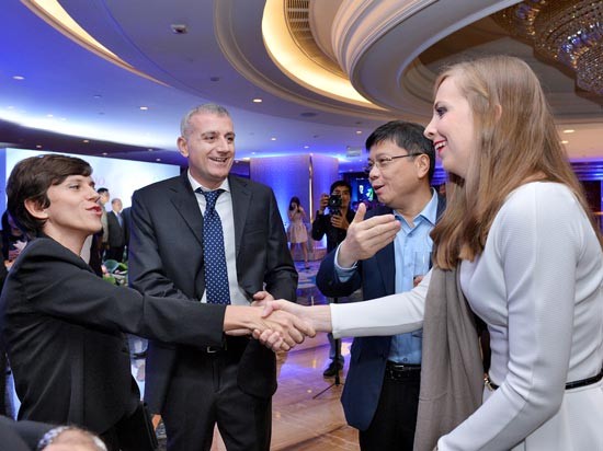 Italian Consul General Carlotta Colli (L) shakes hands with an Italian businesswoman at the gala dinner.